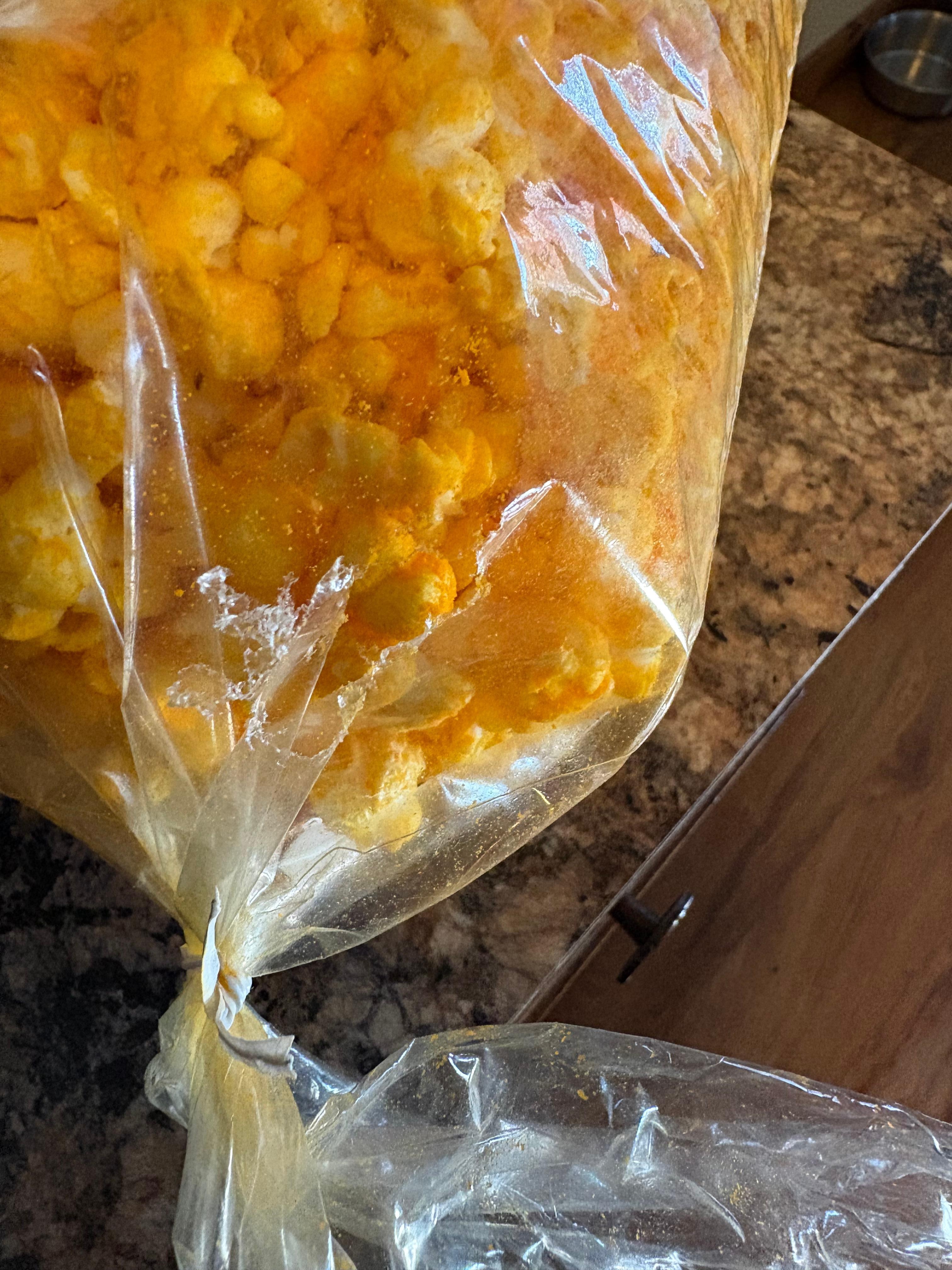 Popcorn bag on kitchen table with hole chewed thru it 
