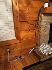 There was this setup and another on the other side of the fireplace running an extension cord up to the loft to a power strip with several things plugged into it.