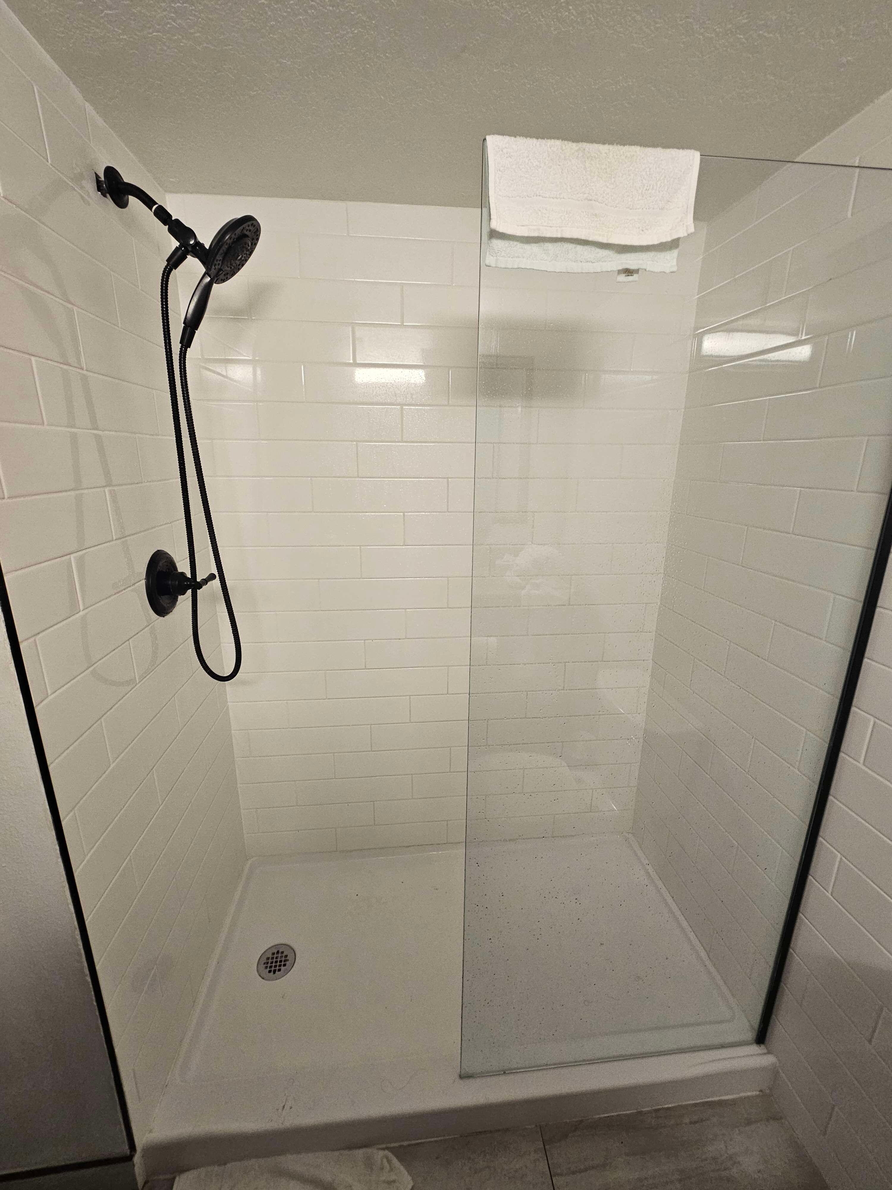 The Shower in question. To the left is the door into the room, so when you use the shower, water would end up all over the floor, and even putting a towel on the floor just led to a soaking wet towel.