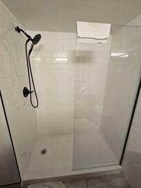 The Shower in question. To the left is the door into the room, so when you use the shower, water would end up all over the floor, and even putting a towel on the floor just led to a soaking wet towel.