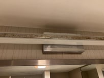 Nicotine stains on light fixture in bathroom