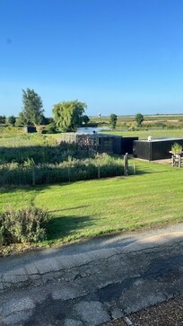View from the front over the neighbouring garden with fishing lakes and wildlife