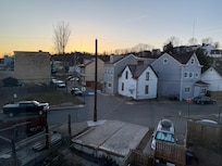 Back of house from top floor, minivan in parking pad