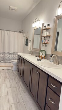 Beautiful comfortable bathroom with attached laundry room, and walking closet