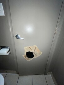 Big hole in the bathroom door and no door lock