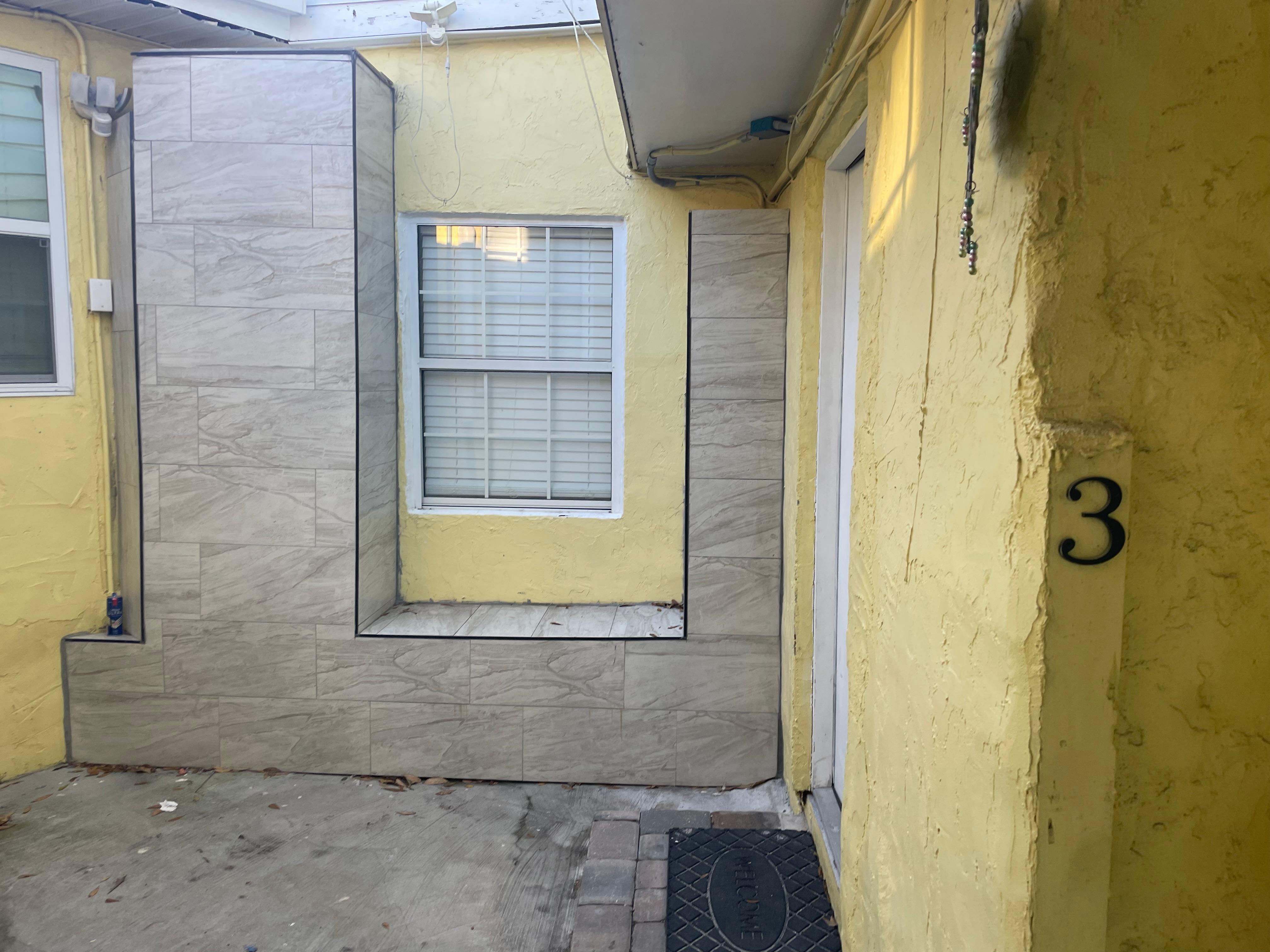 Photo walking through garage/laundry area to door.