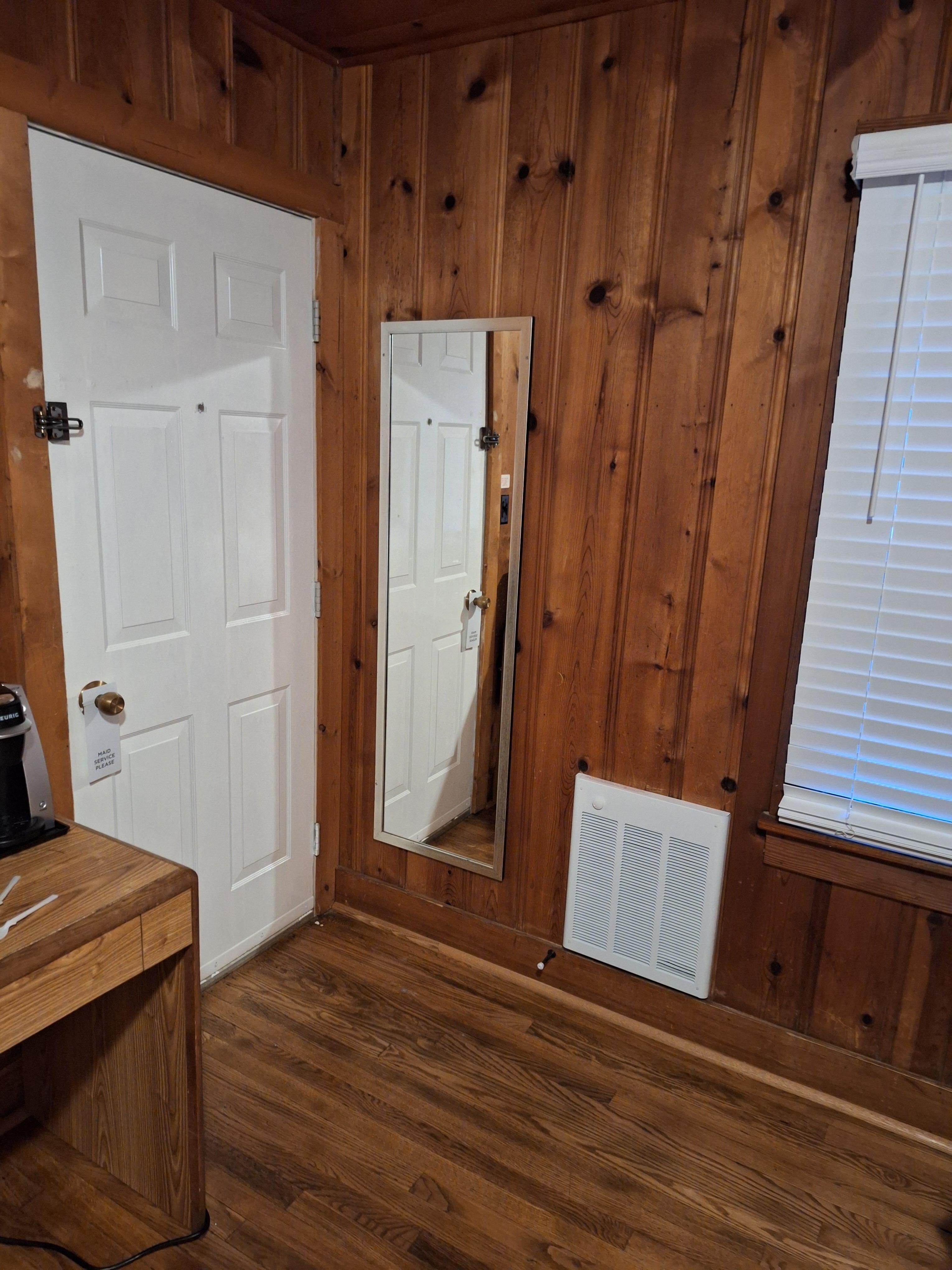 Corner of our room. shows the paneling and the electric heater, flooring. It was warm and cozy. 