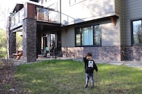 My boy in front of the house while I've hard at work in my new forest-view office...