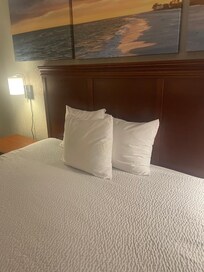 Only 3 miniature pillows for a king side bed.