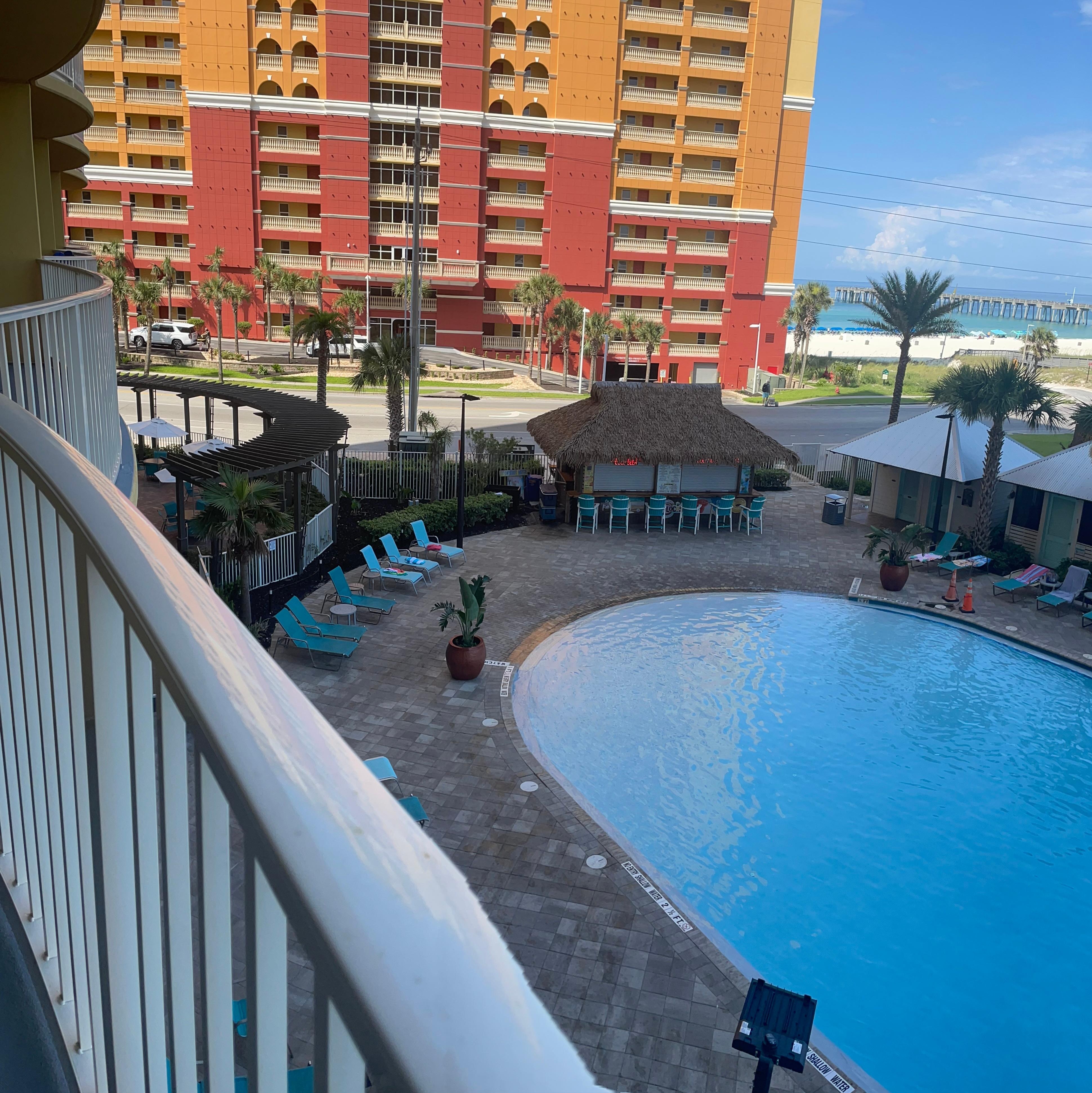 View from the condo deck looking over the pool towards the ocean.