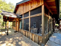 Screened-in dining area off of the kitchen. (Faces prime birdwatching area of garden.)