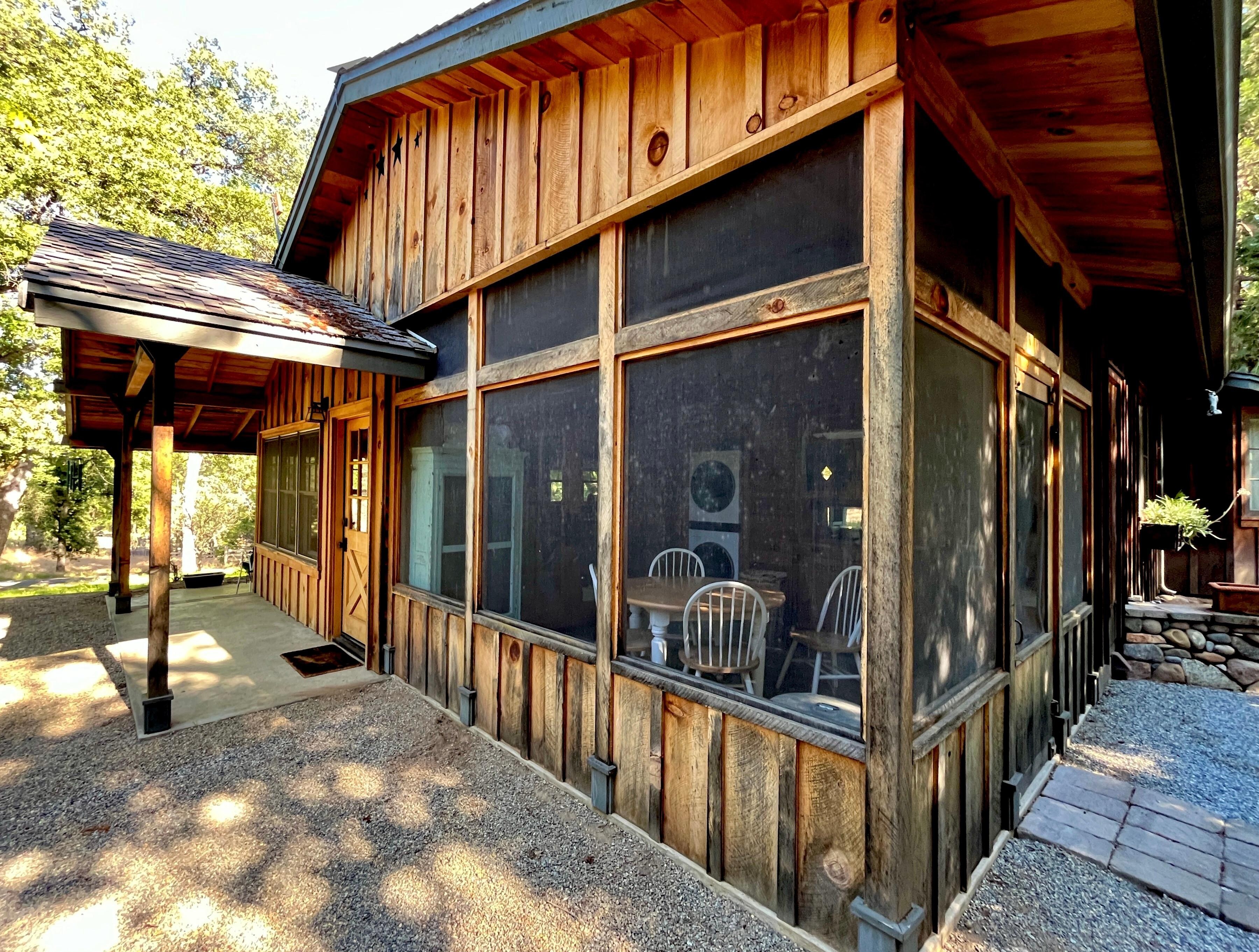 Screened-in dining area off of the kitchen. (Faces prime birdwatching area of garden.)