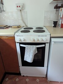 Fire Risk - Exposed cooker wire into wall mounted socket above cooker is not compliant with safety regs.