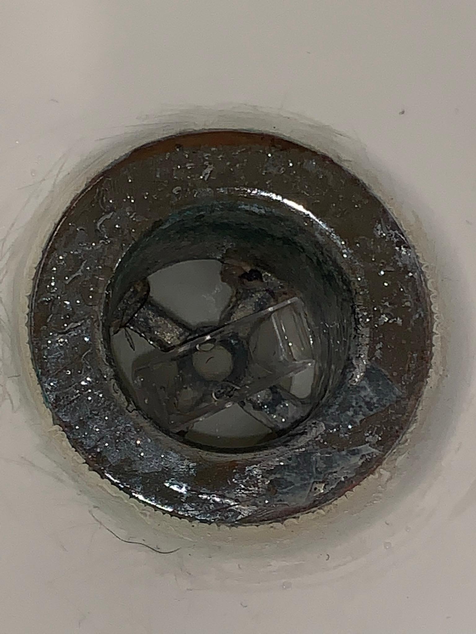 Razor cover left in the drain, tub probably not cleaned.