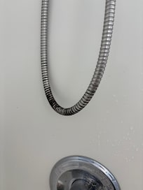 Mold on the showerhead hose. Small bathroom.