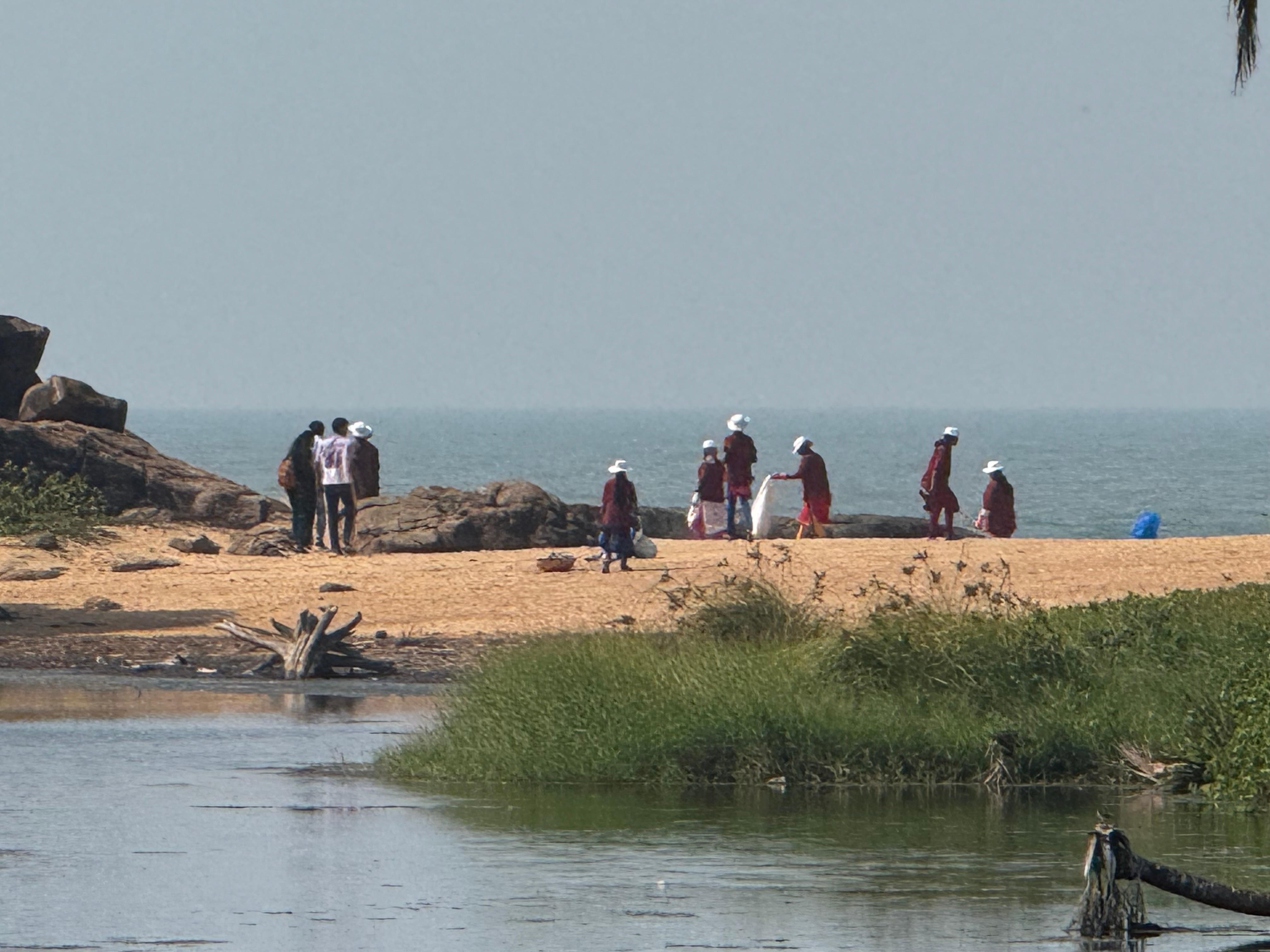 Team collecting beach trash after we reported it