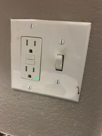 Blood on light switch in bathroom