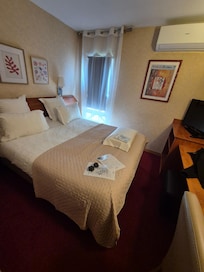 La chambre , petite , mur abîmé