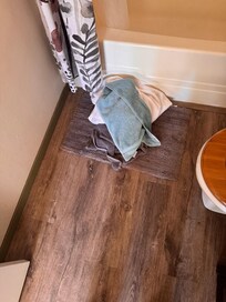 Dirty tub on filthy bathroom flloor