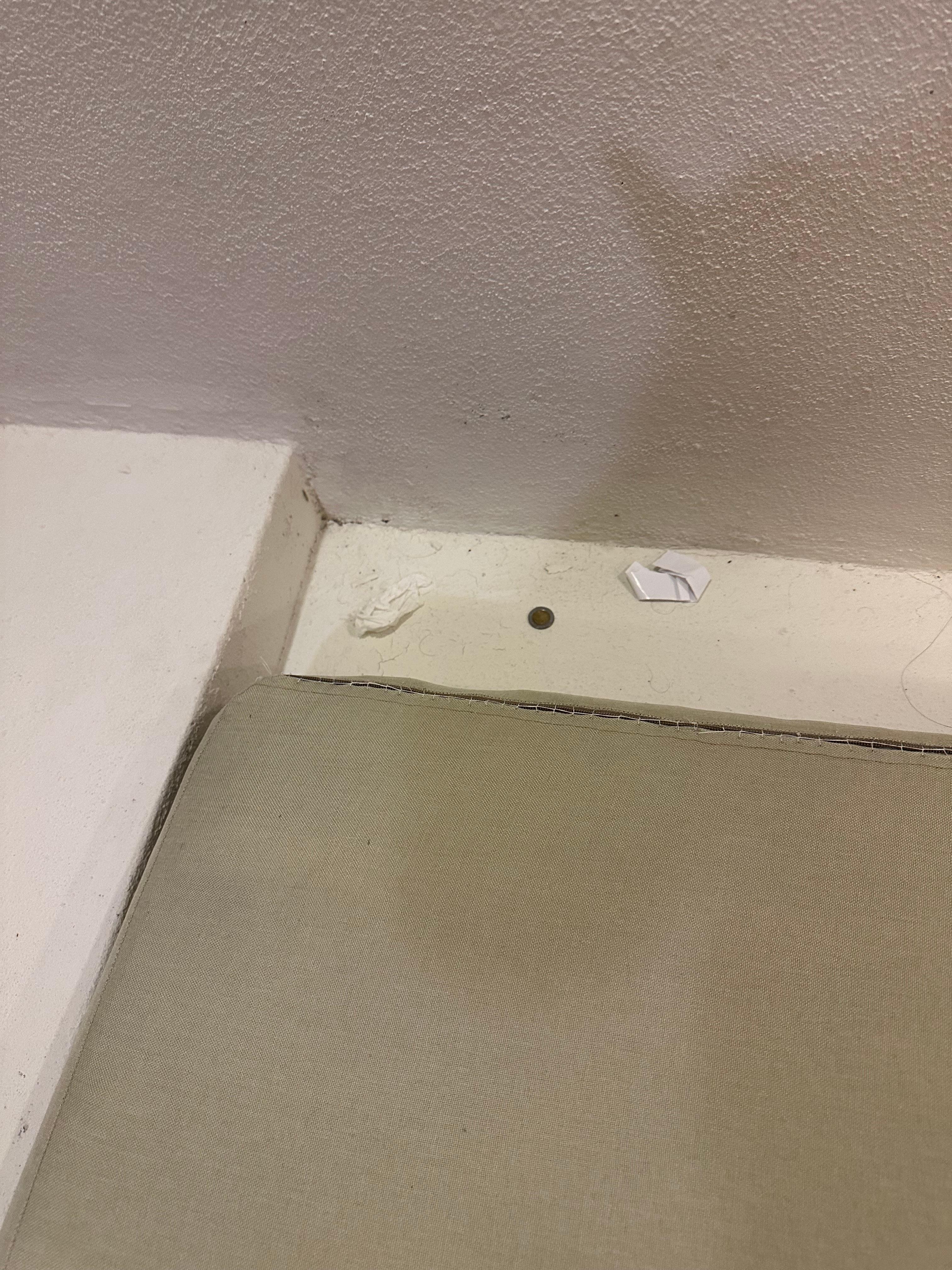 Behind the couch cushion