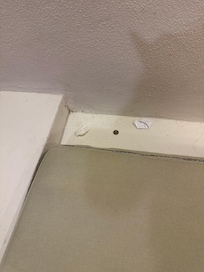 Behind the couch cushion