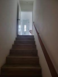 Stairs from ground level to bottom level bedroom area