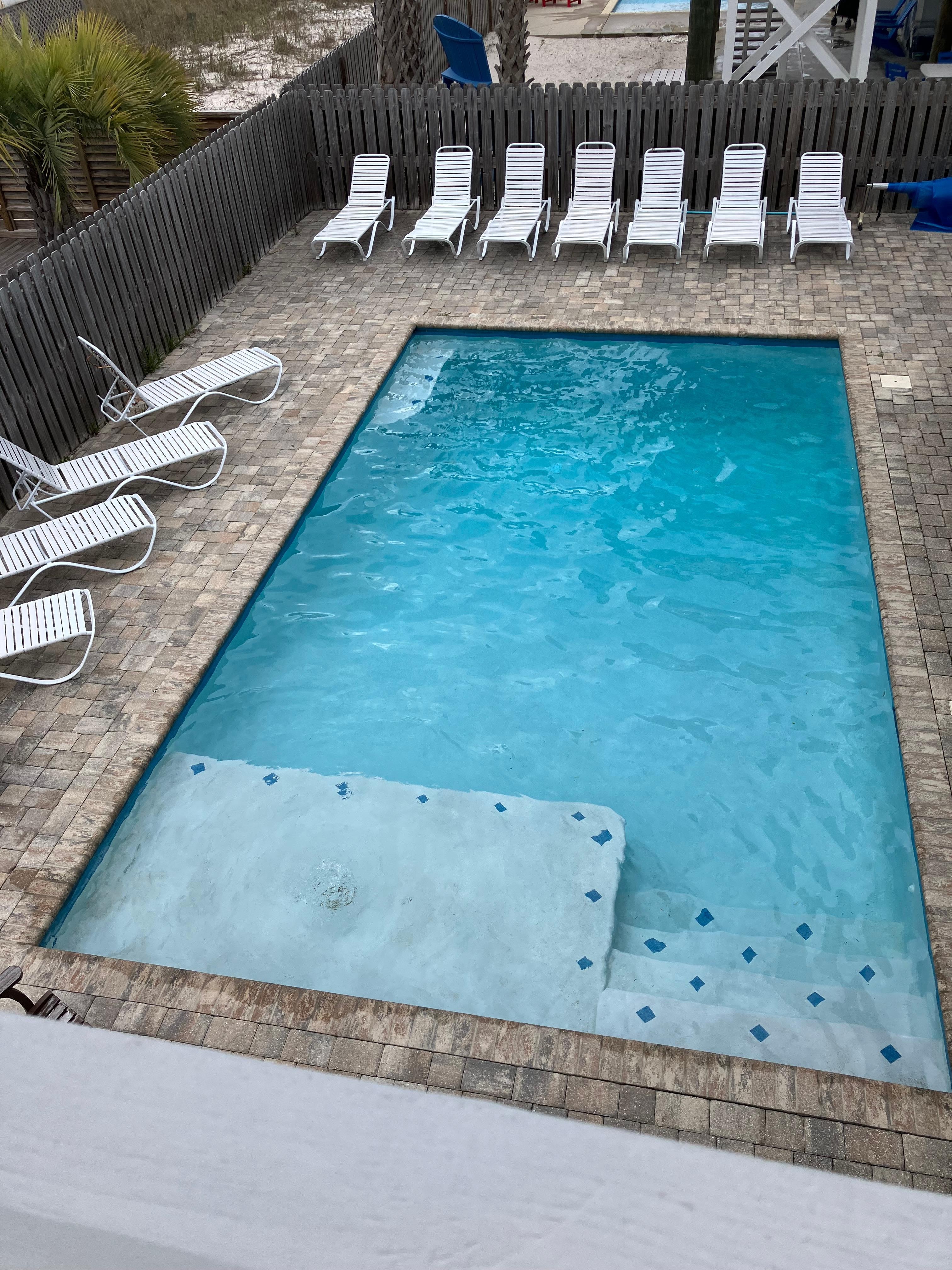 Nice size pool with chairs and BBQ grill