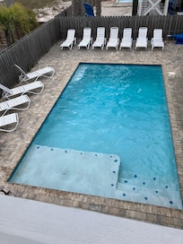 Nice size pool with chairs and BBQ grill