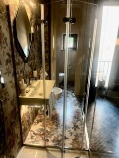 Glass walled bathroom. 