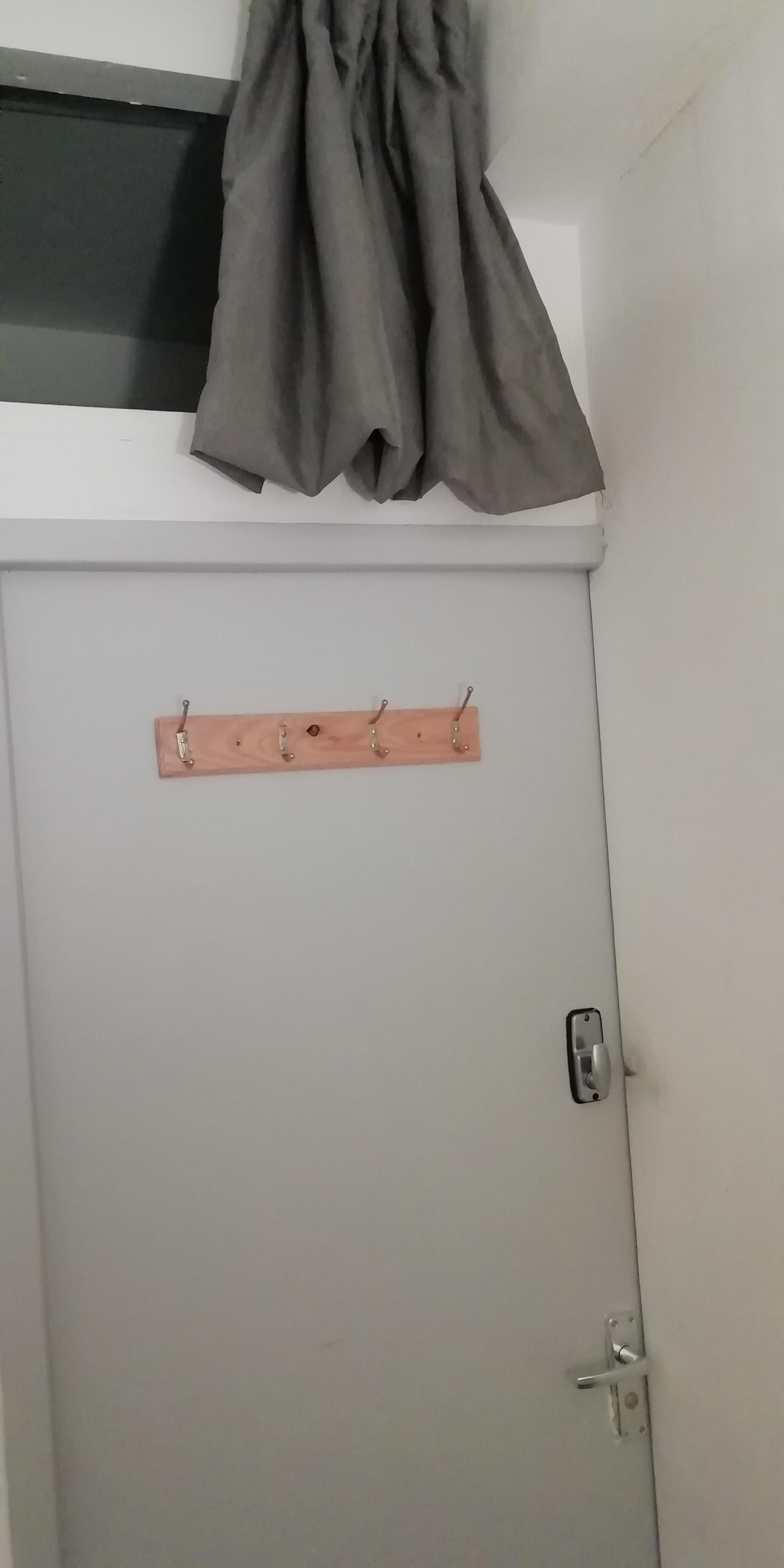 Door to room, with hole above. 