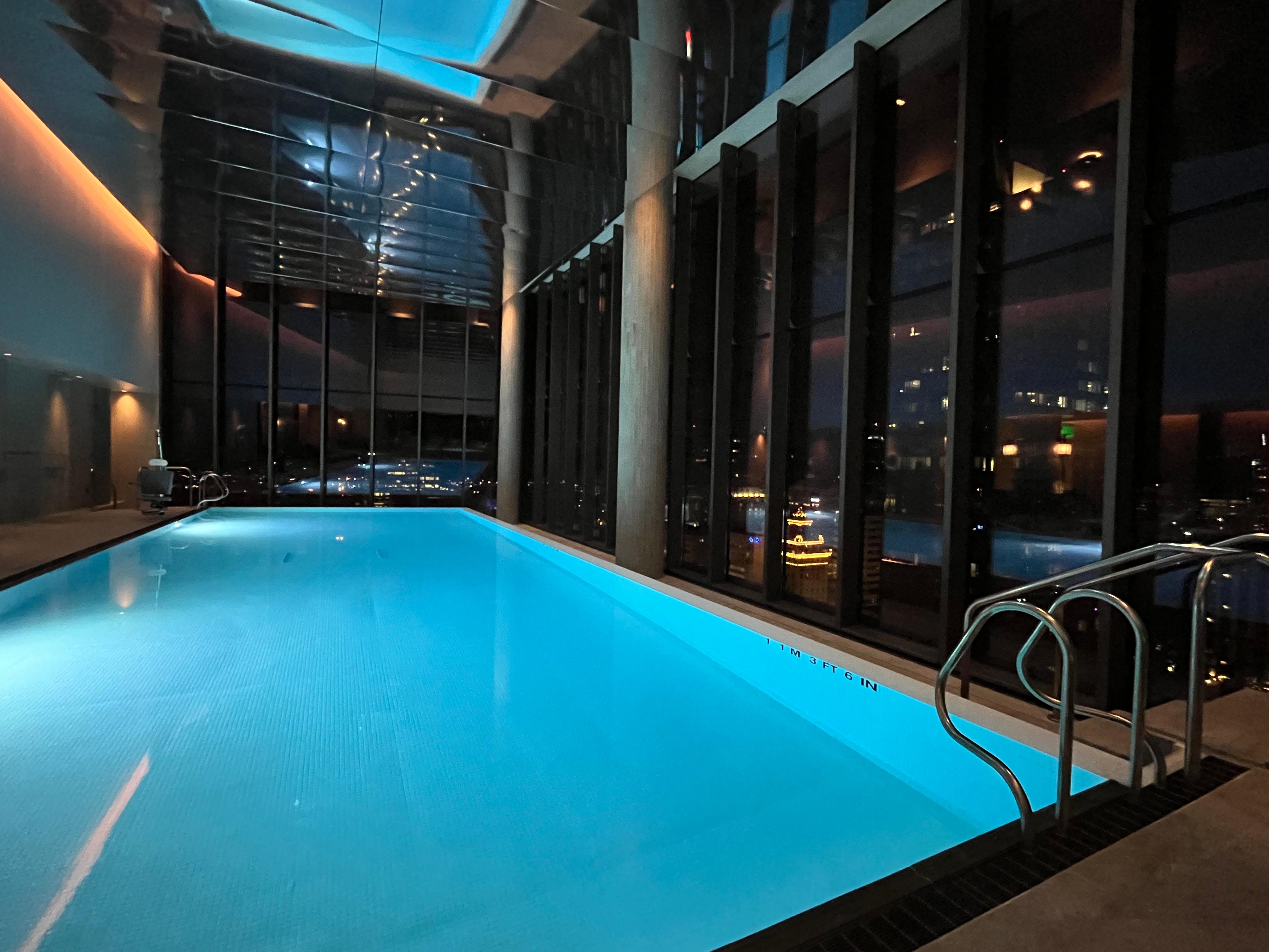 Pool with gorgeous city view at night.