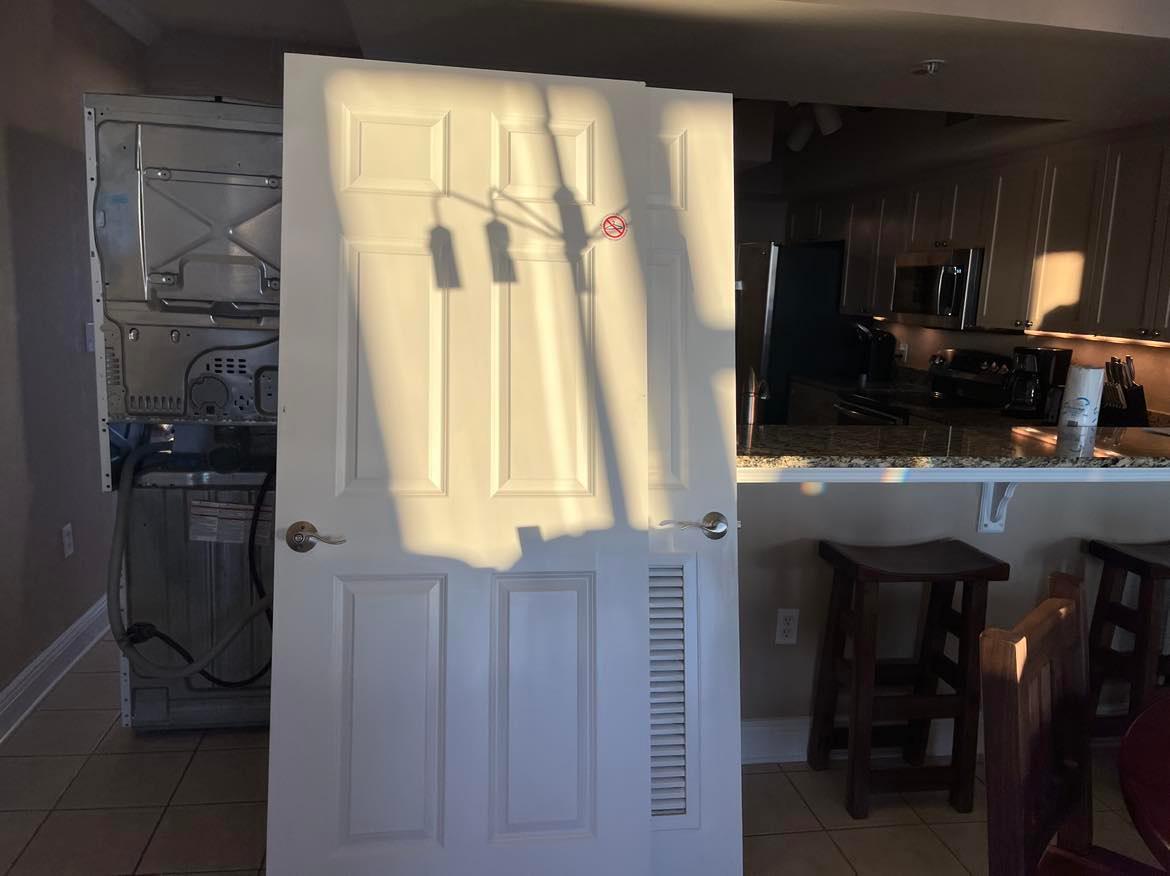 Doors removed in order to move washer and dryer