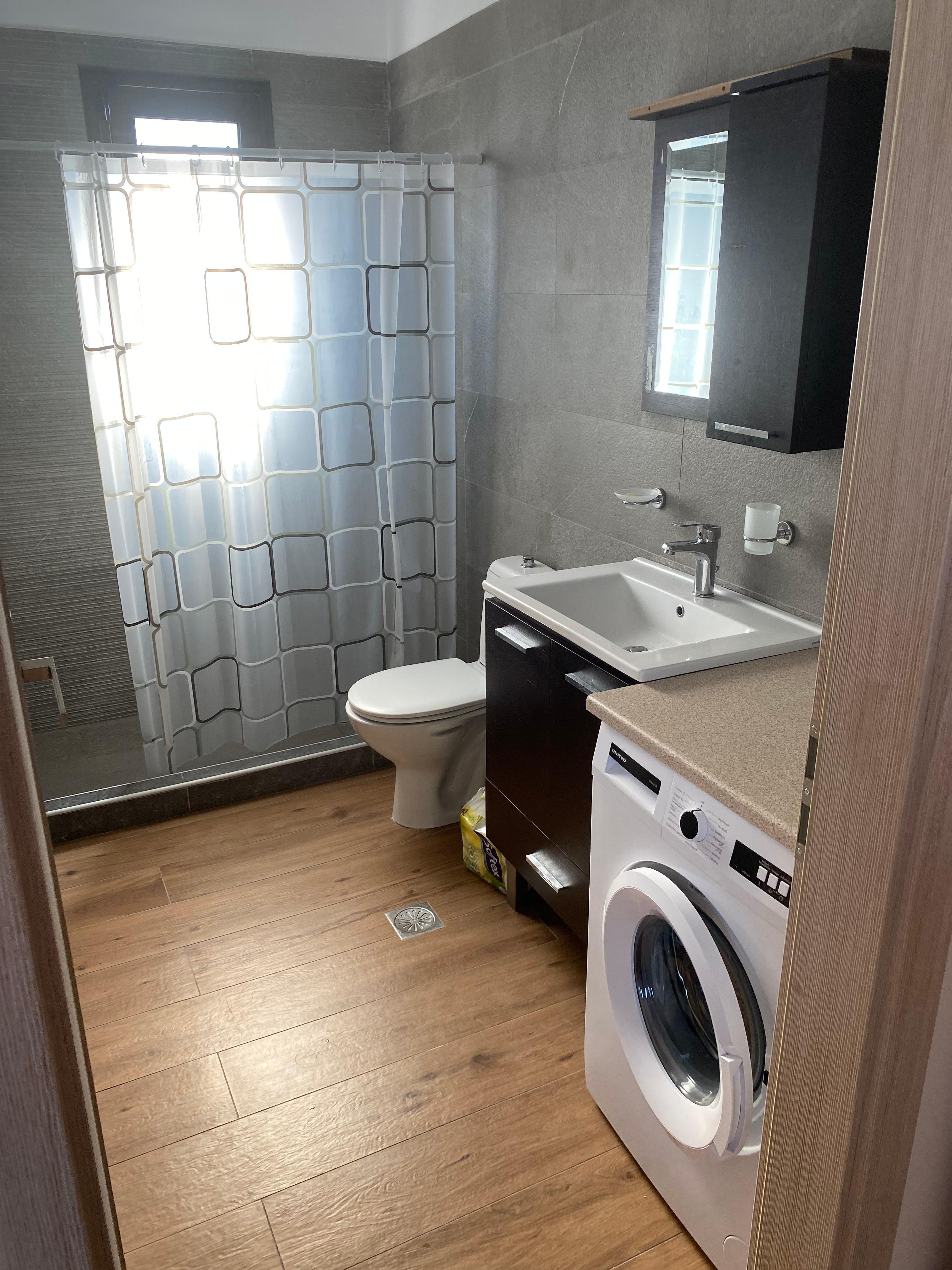 Bathroom with basin, toilet.shower & washing machine