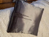 Cushion on the bed with horrible stain on back