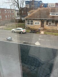 Out a bedroom window Yes sneakers hanging from power lines.