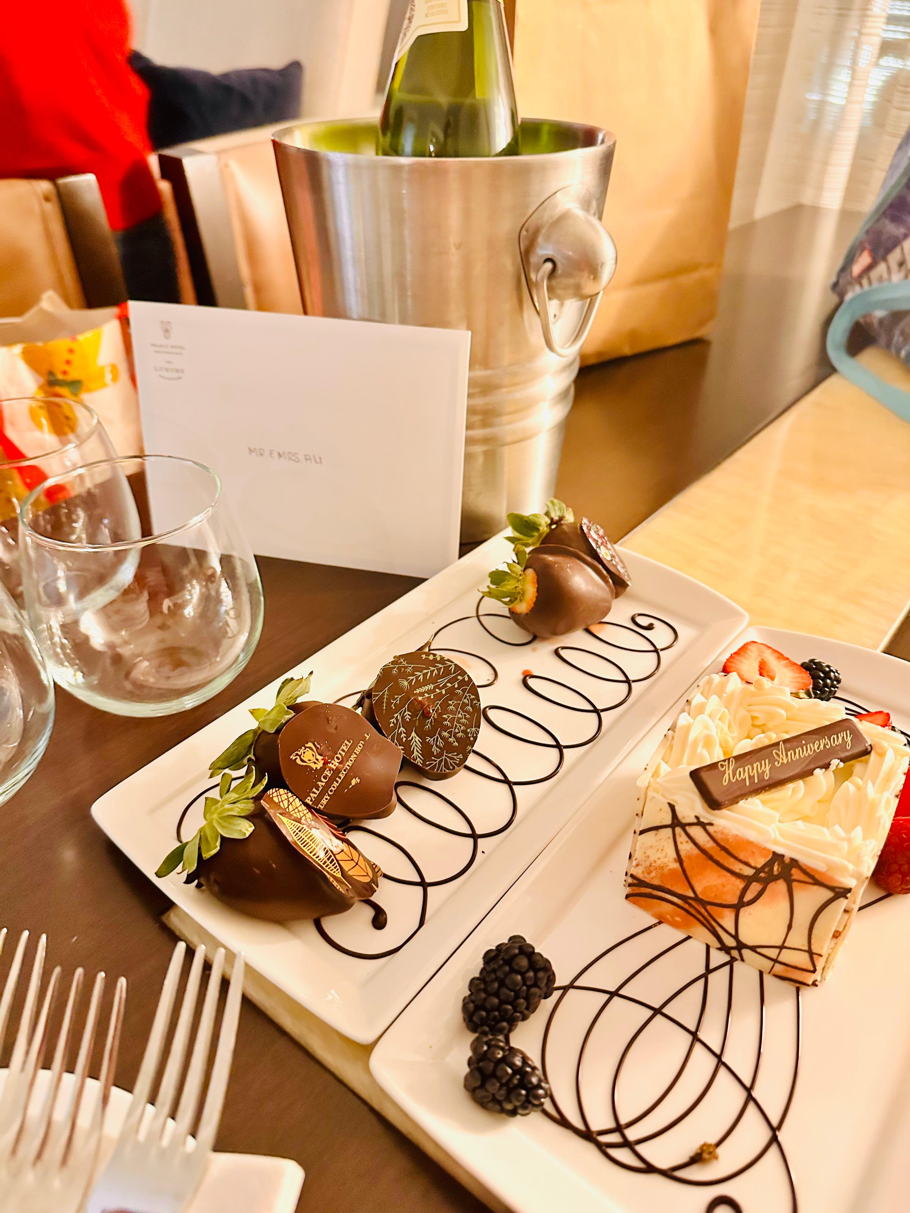 A happy anniversary cake from the hotel along with decorative chocolate covered strawberries 