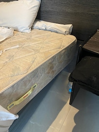 Bed one - stained and torn mattress and sheet