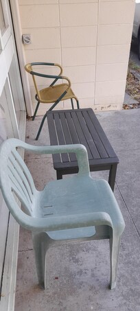Very old miss matched furniture on the porch.