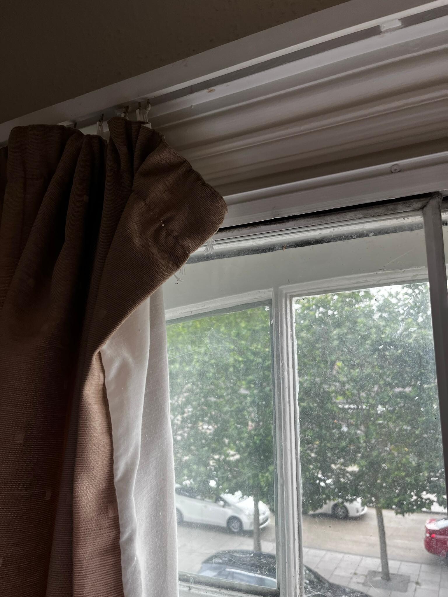 Curtain hanging loose.