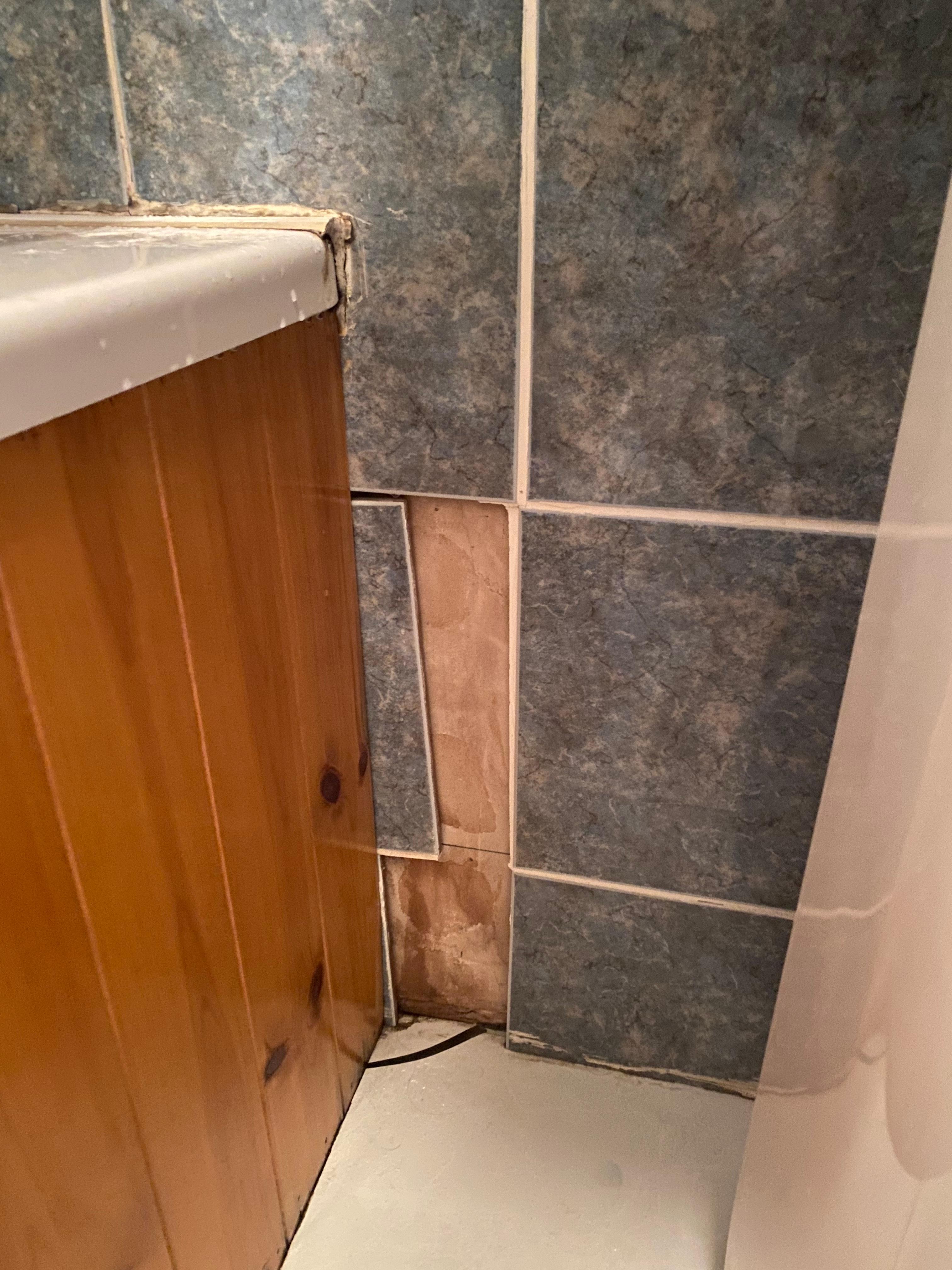 Tiles under sink hanging off