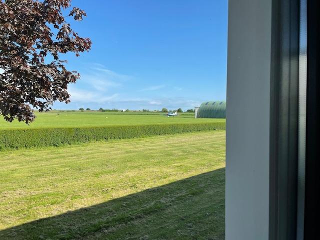 View of part of the airfield from the bedroom