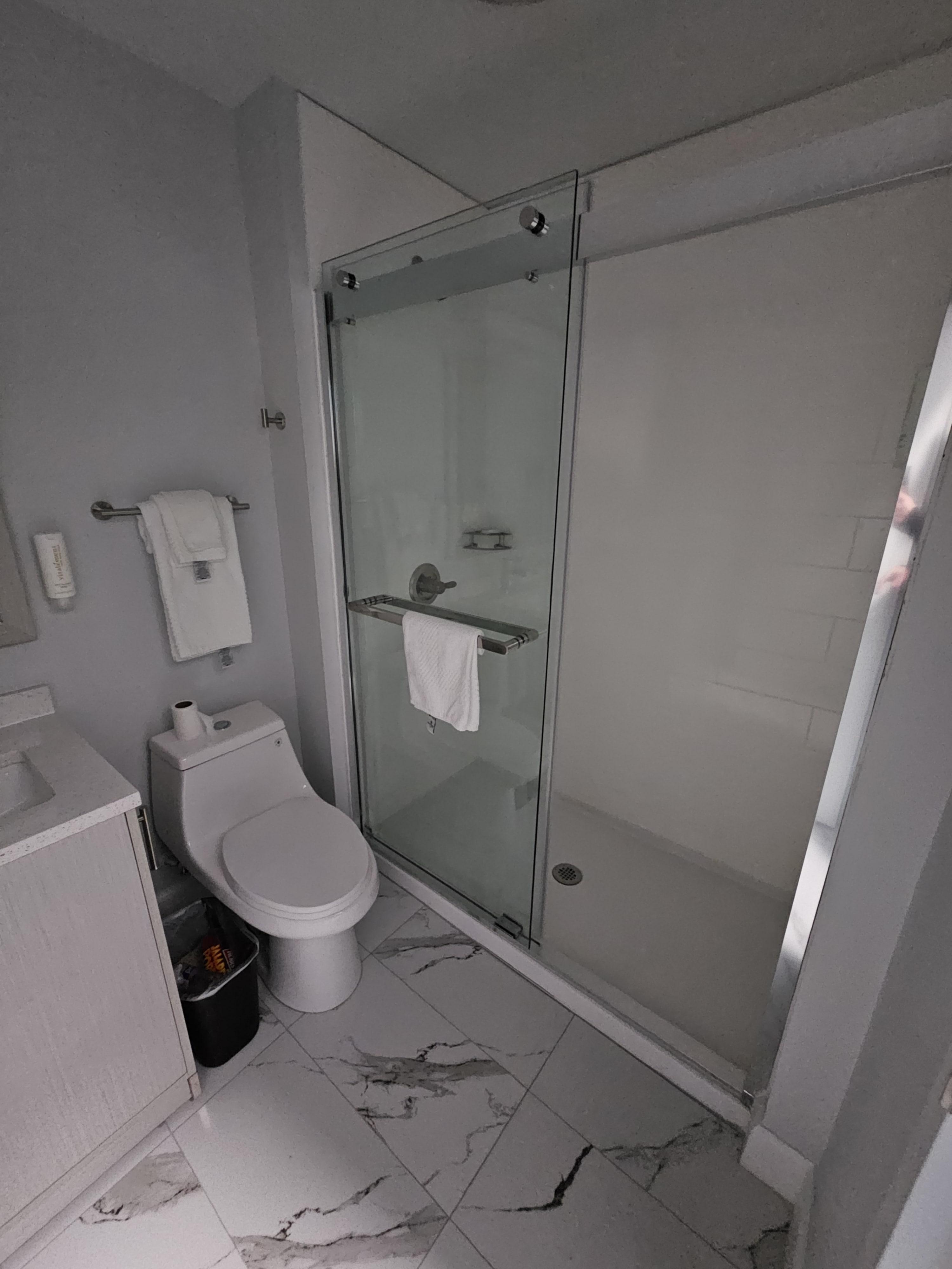 Bathroom. Spacious shower that already has shampoo and conditioner inside. Comes with two bars of soap. Mini hairdryer installed on the wall.