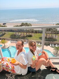 My friend that visited over looking our resort pool grounds from our balcony on the 6 th floor.