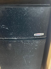 The mini fridge very scratched up
