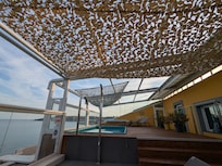 Pool with jets and a shower head.