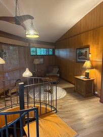 Cute little reading nook at top of spiral stairs