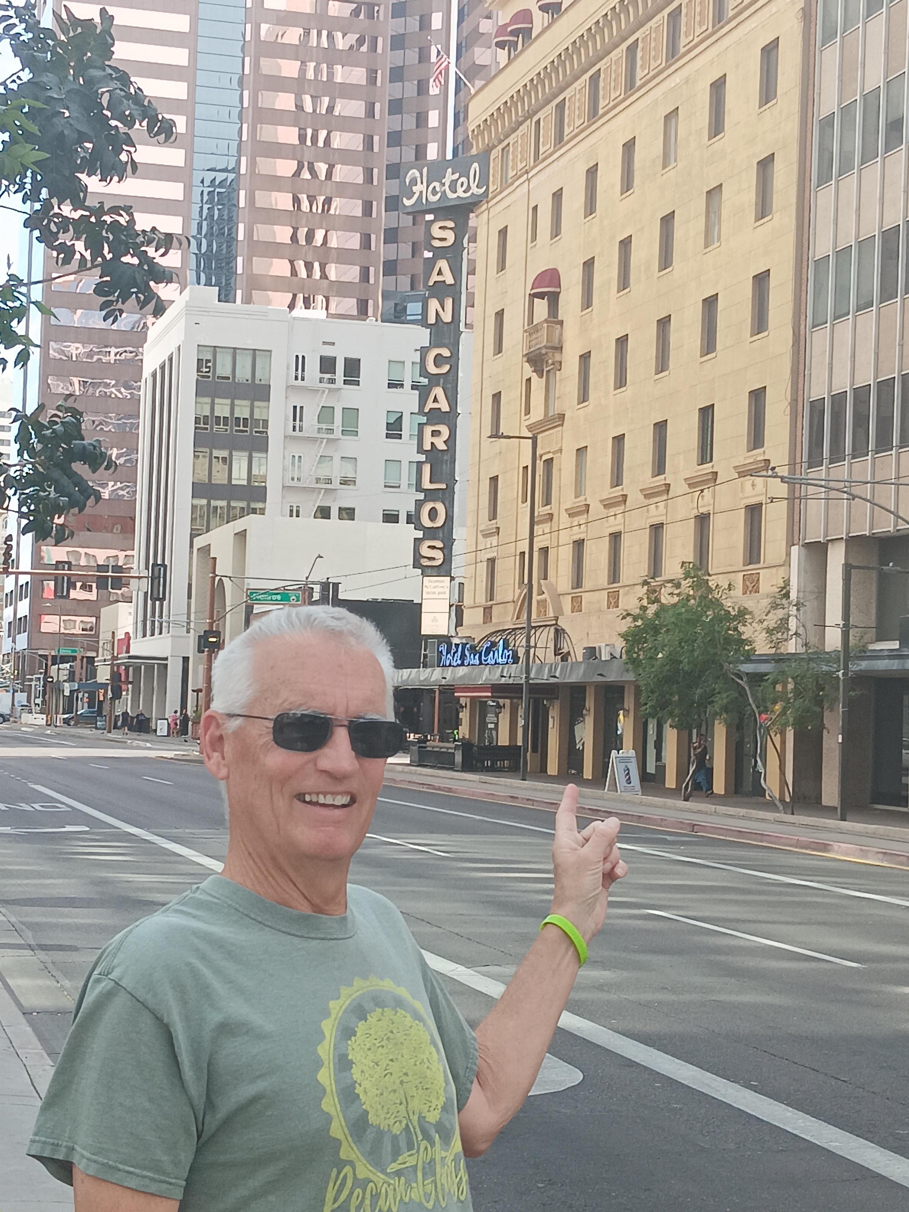 In the heart of downtown. Sign glows blue at night.