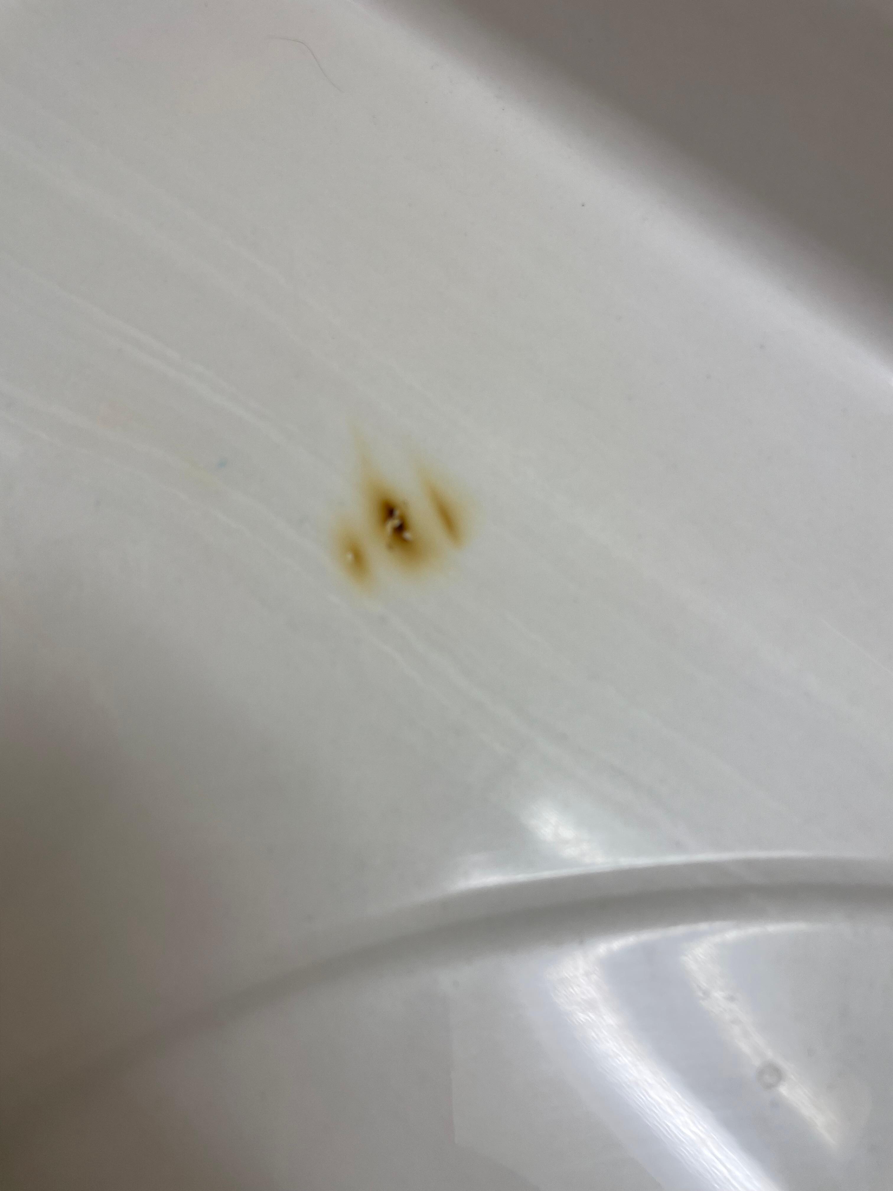 Cigarette burns on the bathroom counter 