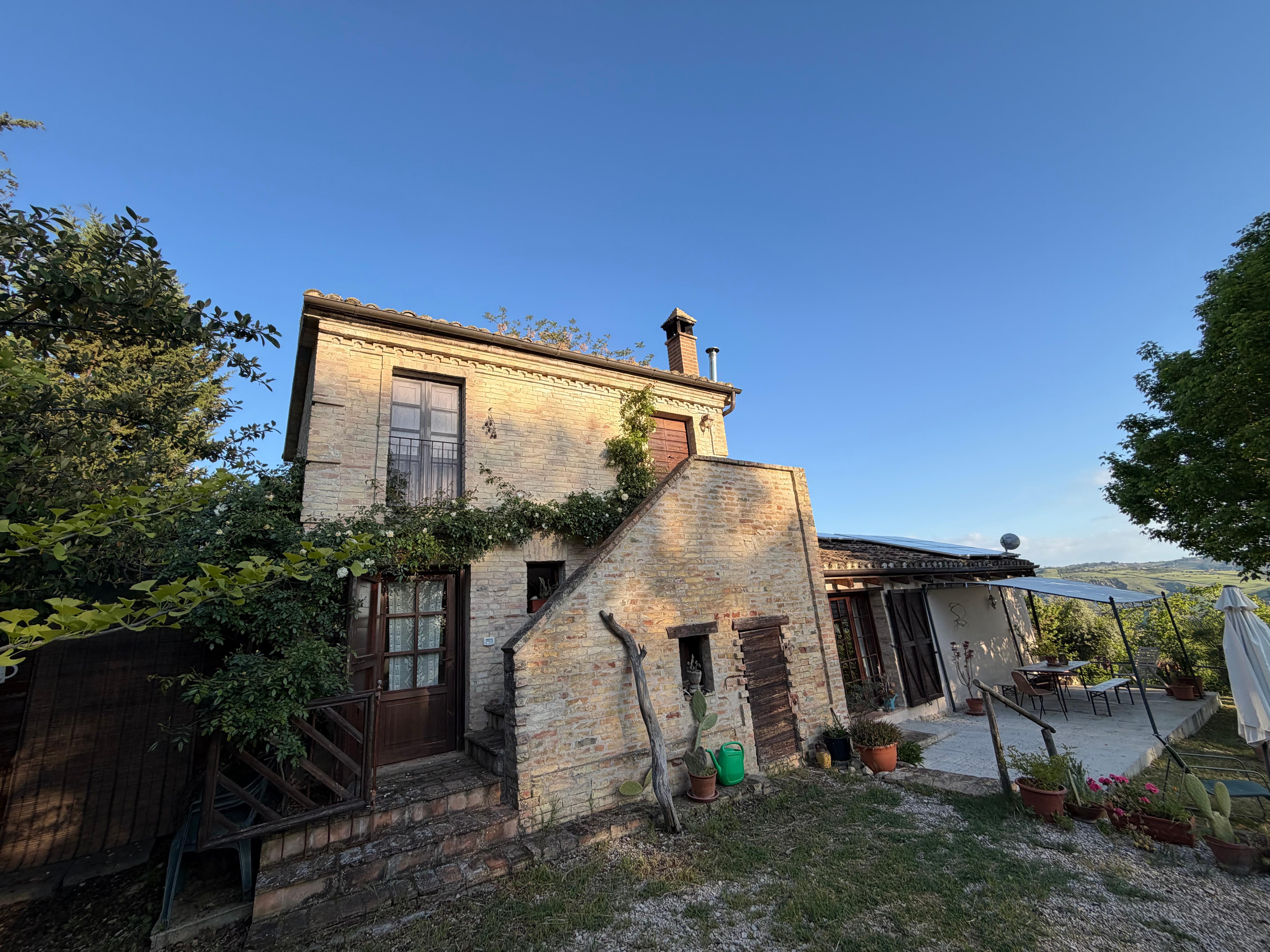 Beautiful stone farmhouse covered in white roses