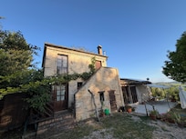 Beautiful stone farmhouse covered in white roses